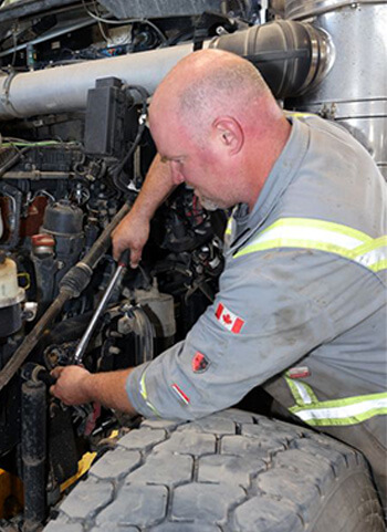 Mechanic working on heavy equipment engine